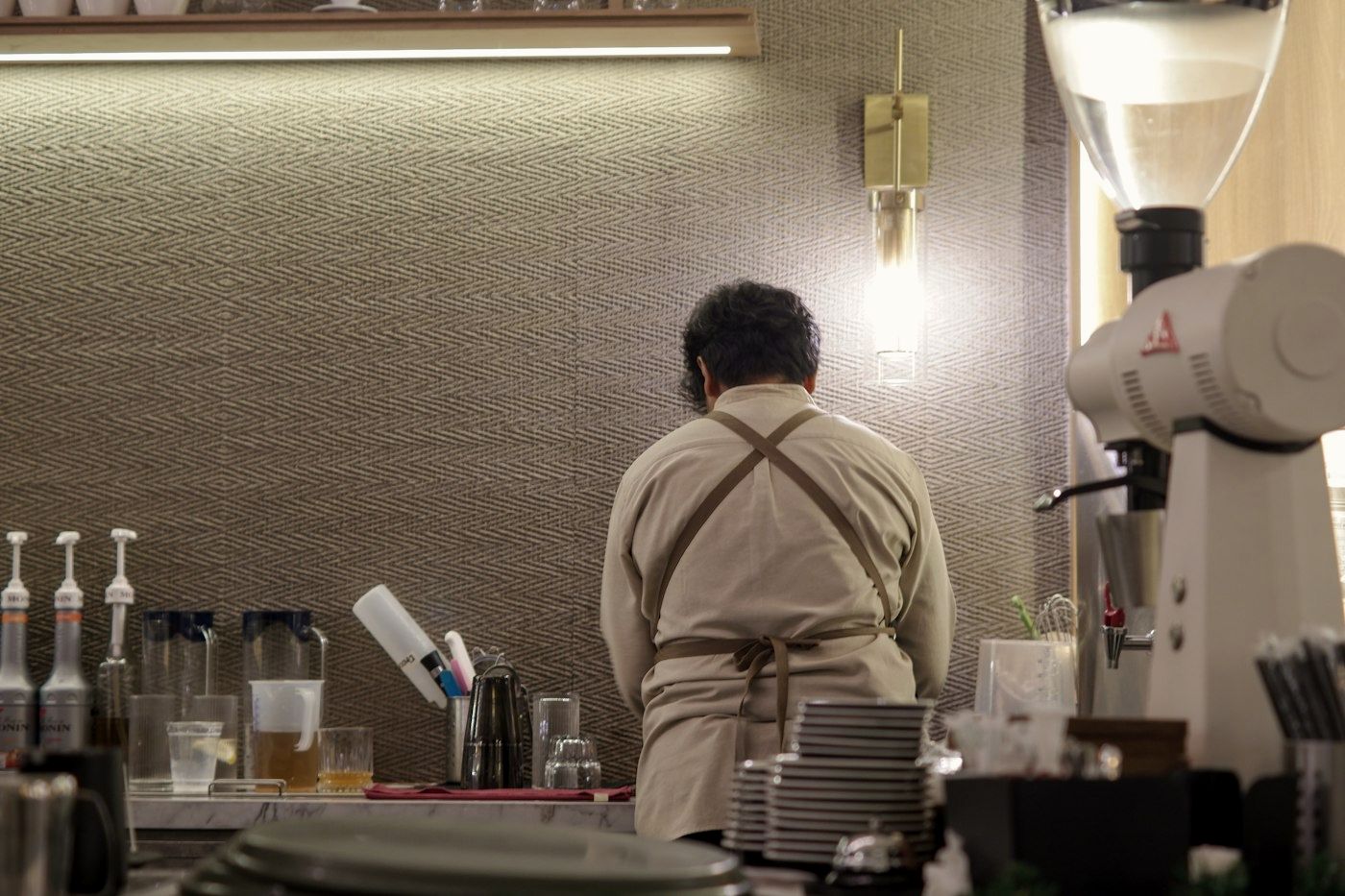 A barista working behind a café counter